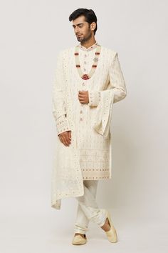 Cream sherwani embroidered with honeycomb patterns, embellished by sequins and pearls. Comes with a churidar. - Aza Fashions White Semi-stitched Sherwani With Mirror Work, Festive Sherwani With Chikankari Embroidery For Reception, Festive Reception Sherwani With Chikankari Embroidery, White Bollywood Bandhgala With Mirror Work, Kundan Kurta For Eid Reception, Eid Reception Traditional Wear With Chikankari Embroidery, Traditional Sherwani With Mirror Work, Traditional Sherwani With Mirror Work For Transitional Season, Traditional Sherwani With Mirror Work For Eid