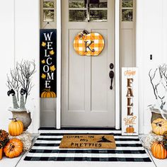 the front door is decorated for halloween with pumpkins and jack - o'- lanterns