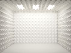 an empty room with white walls and geometric shapes on the wall, as if it was made from plastic