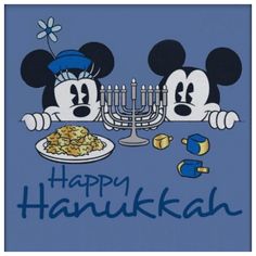 two mickey mouses sitting at a table with a hanukkah menorah