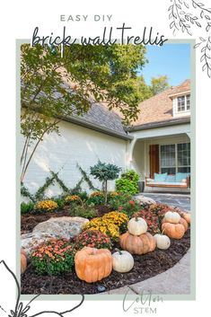 a house with pumpkins and flowers in the front yard