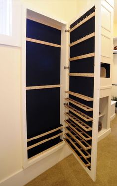 an open closet with shelves and drawers in it