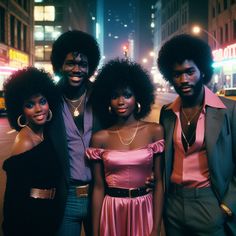 three people standing next to each other in front of a city street at night time