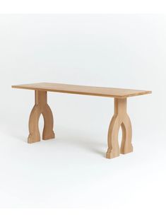 a wooden table with an arch design on the top and legs, against a white background