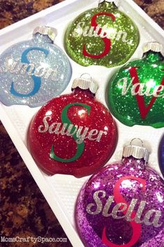 six personalized christmas ornament in a box with the names and numbers on them