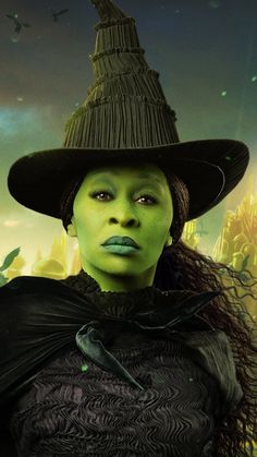 a woman in a witch costume with green eyes and black hair wearing a large hat