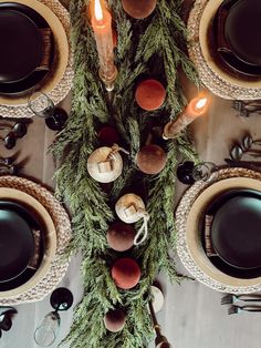 an overhead view of a table setting with candles and plates