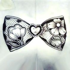 a drawing of a bow tie with flowers and hearts on it's front side