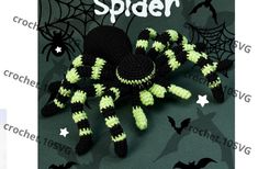 a crocheted black and green spider with white stripes