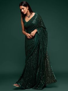 This Emerald Green sequinned georgette saree comes with an unstitched blouse. Wear it to garden parties or weddings, you are guaranteed to make heads turn. This classic piece makes needs no further styling making it a versatile piece for any and every event. Standard and Customized blouse stitching available for an additional fee. Please note this blouse can be stitched up to a size 44, and cannot be made with sleeves. For the customized option, our team will reach out to you after the order is Green Sari, Sequins Saree, Evening Reception, Sequence Saree, Sequin Saree, Party Sarees, Color Blouse, Party Wear Saree, Red Lehenga