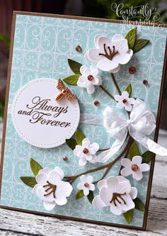 a card with white flowers on it and a tag that says, always and forever