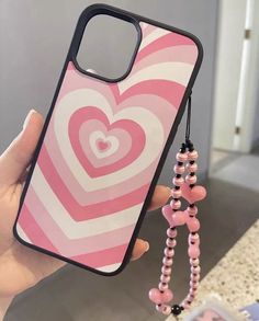 a pink and white heart phone case with beads