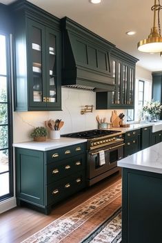 a kitchen with dark green cabinets and white counter tops, an area rug on the floor