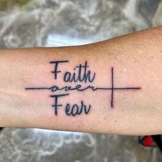 a tattoo with the words faith and fear on it