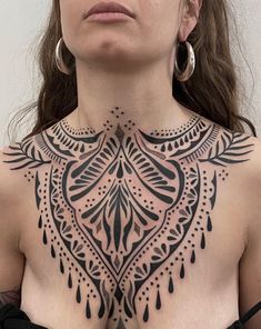 a woman with tattoos on her chest