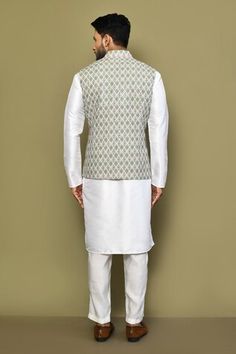 Green sleeveless bundi with all over blossom motif print. Paired with a white full sleeves plain kurta and a pant. - Aza Fashions Sleeveless Nehru Jacket For Diwali, Sleeveless White Kurta For Diwali, White Sleeveless Nehru Jacket For Spring, Spring White Nehru Jacket With Floral Print, White Resham Embroidery Nehru Jacket, Ceremonial White Naqshi Nehru Jacket, White Semi-stitched Long Sleeve Nehru Jacket, Luxury Single-breasted Long Sleeve Nehru Jacket, Fashion App