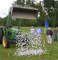 people standing in the grass near a green tractor and blue flag with white balls on it