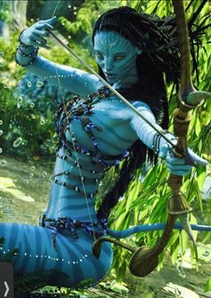 a woman dressed in blue holding a bow and arrow