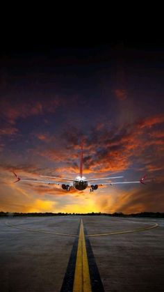 an airplane is taking off into the sunset