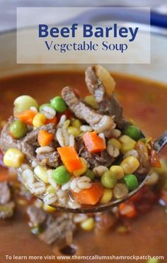 a spoon full of beef and vegetable soup with text overlay that reads beef barley vegetable soup