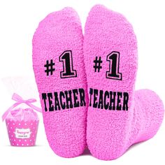 two pink slippers with the number one on them next to a cupcake box