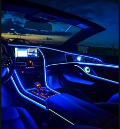 the interior of a car is lit up with blue lights