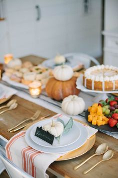 a table topped with lots of food and plates filled with cake on top of it