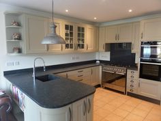 a kitchen with an island, stove and oven