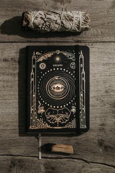 an open book sitting on top of a wooden table next to a piece of string