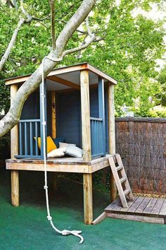 a tree house with a ladder to the roof