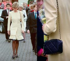 the woman is wearing a dress and carrying a black handbag while walking down the street