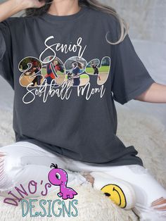 a woman sitting on top of a bed wearing a t - shirt that says senior softball mom