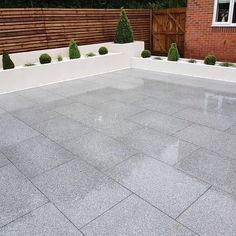 an empty patio with potted plants on the side