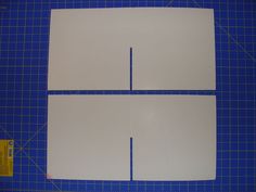 three pieces of white paper on a blue cutting mat