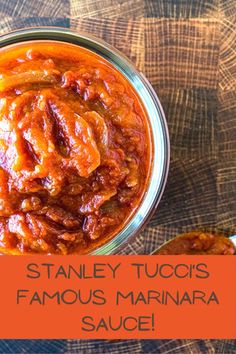 a jar filled with sauce sitting on top of a wooden table