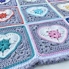 a crocheted blanket with hearts on it