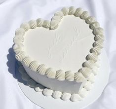 a heart shaped cake sitting on top of a white plate