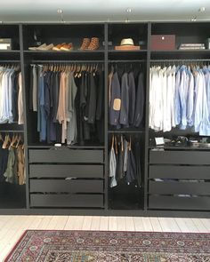 an organized closet with drawers and clothes hanging on the walls, carpeted flooring