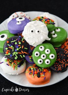 there are many decorated donuts on the plate with sprinkles and eyes