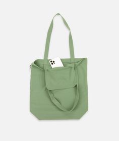 a green tote bag with a tag on it