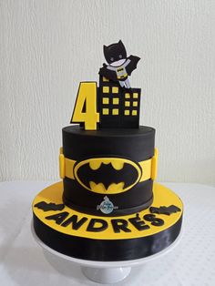 a batman themed birthday cake with the number four on top