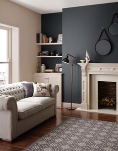 a living room filled with furniture and a fire place in front of a large window