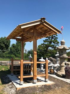 a wooden gazebo sitting in the middle of a park