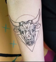 a bull head tattoo on the left inner arm