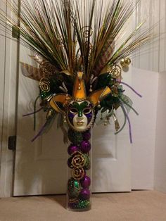 a vase filled with lots of different types of decorations on top of a floor next to a door