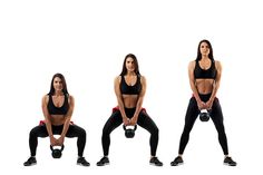 a woman doing squats with kettles in three different positions