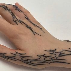 a person's hand with black ink on it and an intricate design in the middle