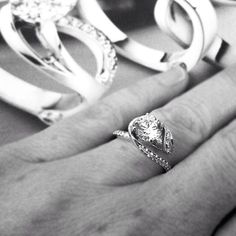 a woman's hand with two rings on top of it and one ring in the middle