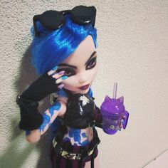 a doll with blue hair holding a purple drink