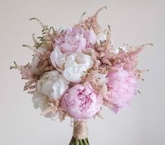 pink and white flowers in a vase on a table